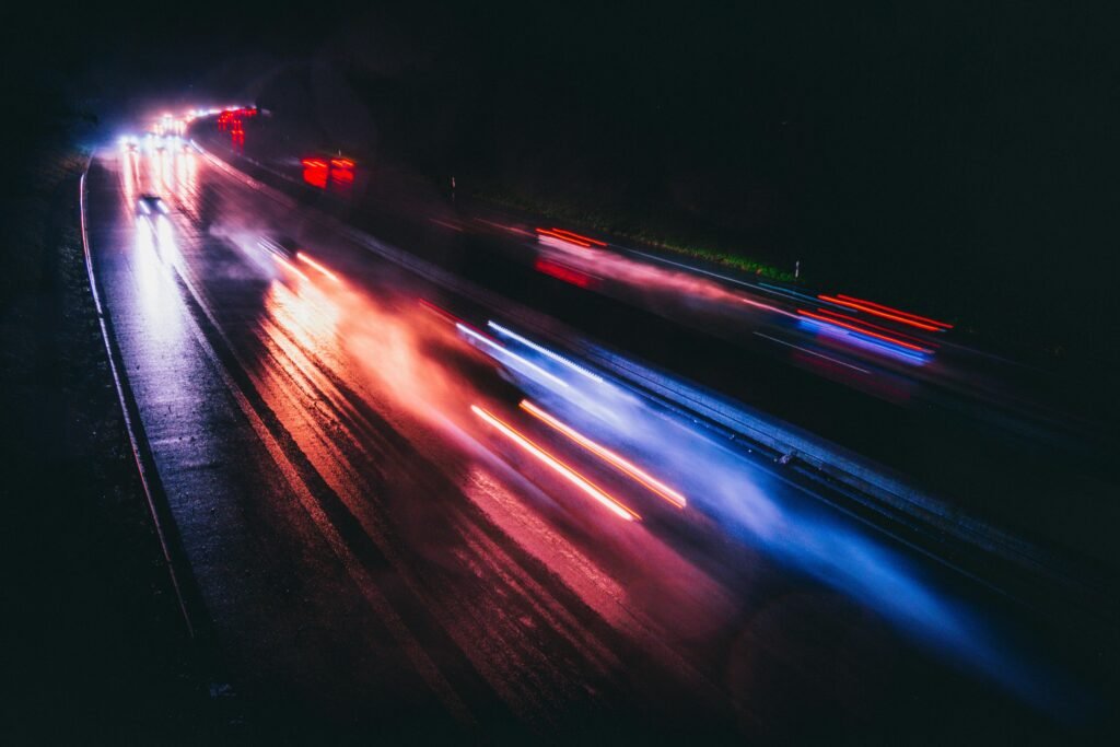 pexels-photo-14864963-14864963 Long exposure photo capturing vibrant light trails on a rainy highway night.